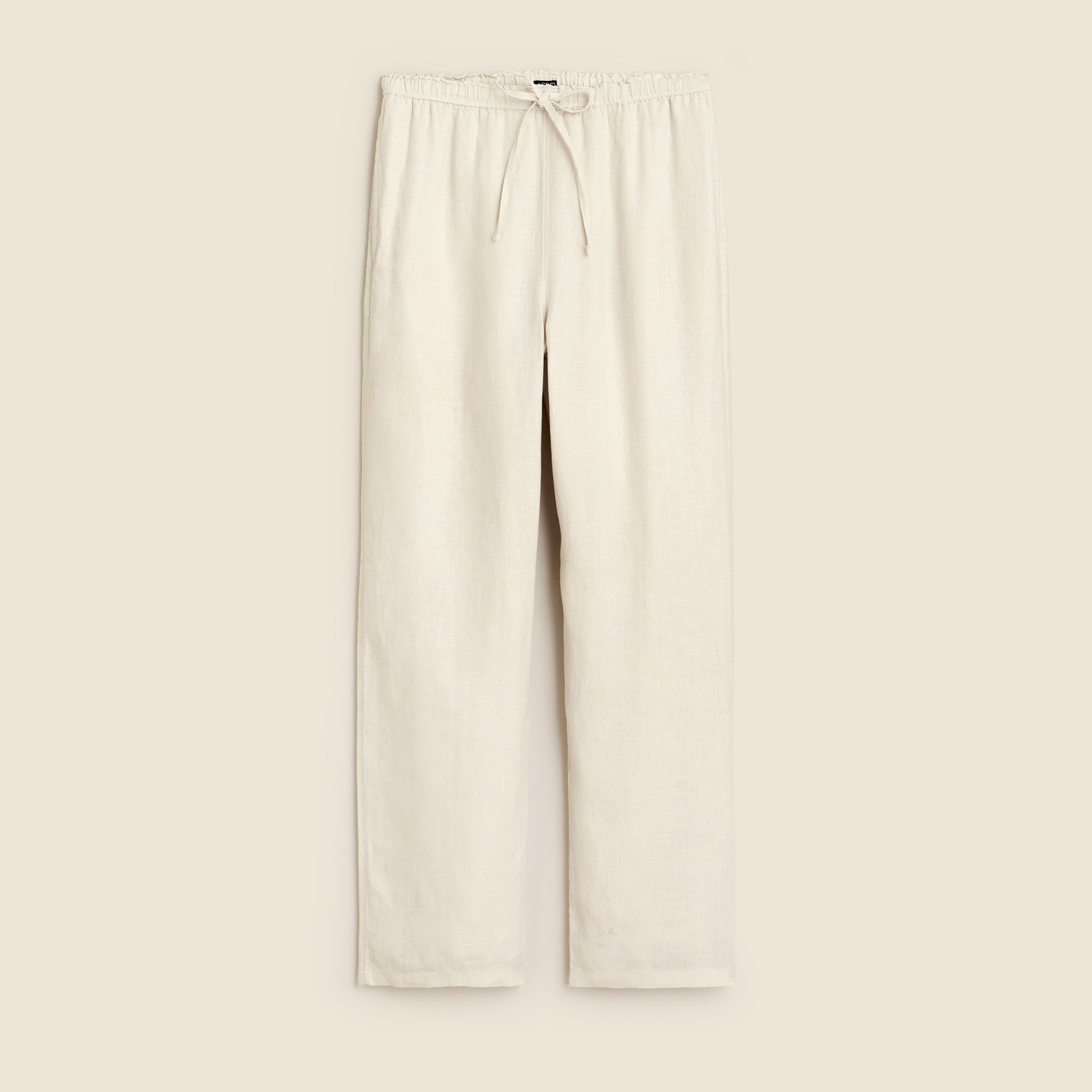 A pair of light beige linen women's pants with an elastic waistband and drawstring, shown flat against a neutral background.